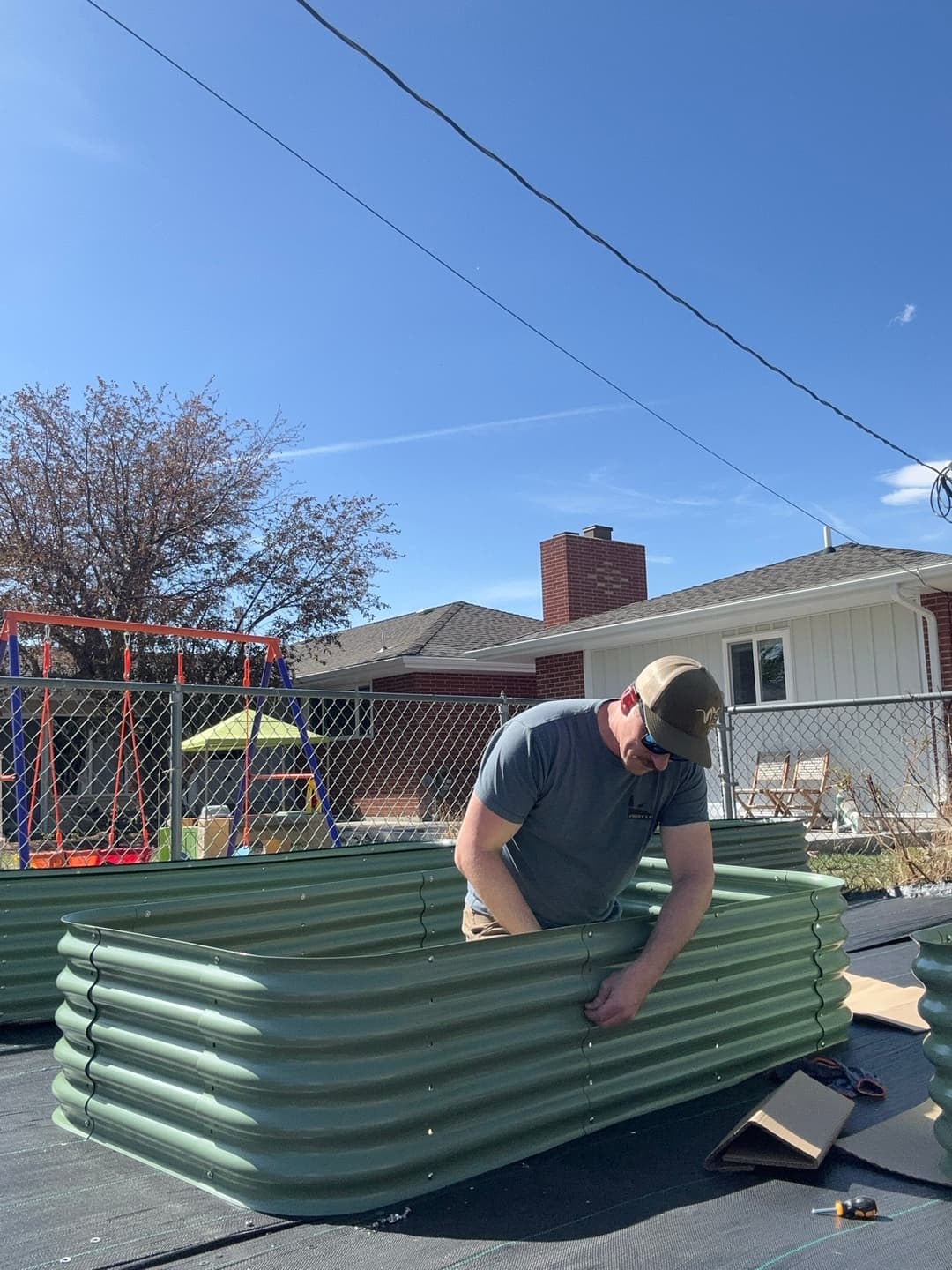 Assembling a VEGEGA modular raised garden bed on cardboard base layer